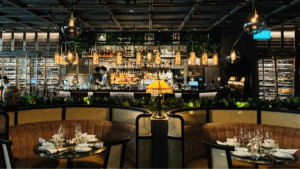Restaurant interior with booth-style tables and staff behind the bar